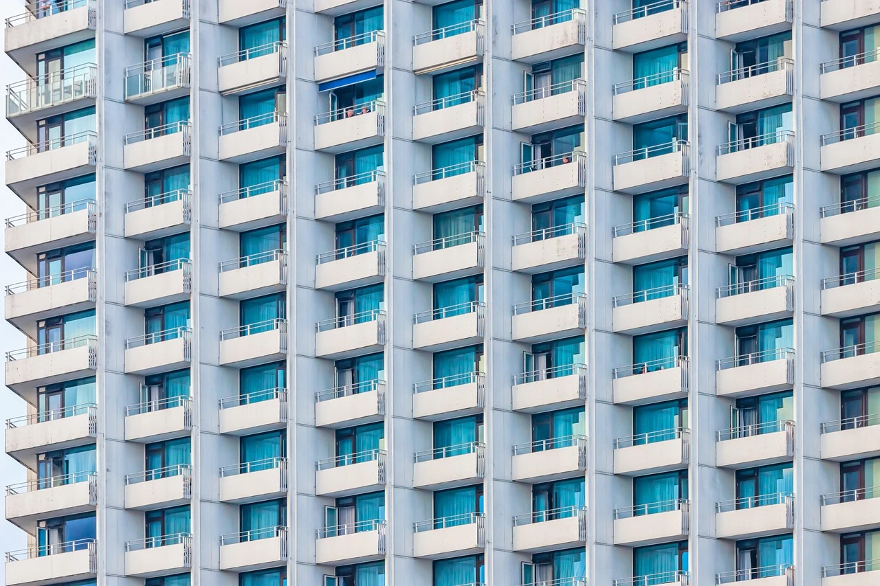 The facade of an apartment building, balcony after balcony in
                    repeating rows.
